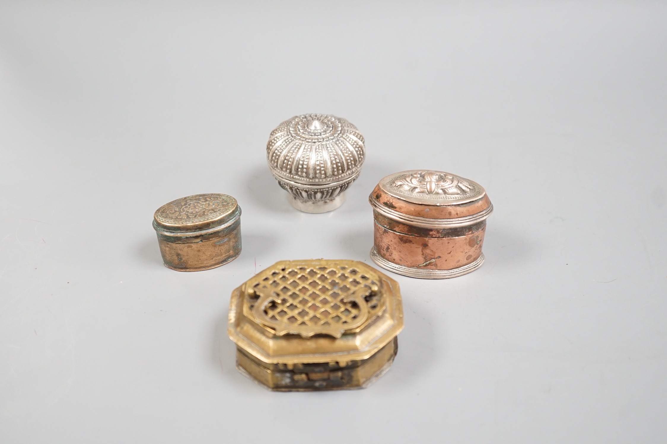 Four southeast Asian metal Betel nut containers, largest 7.5 cm